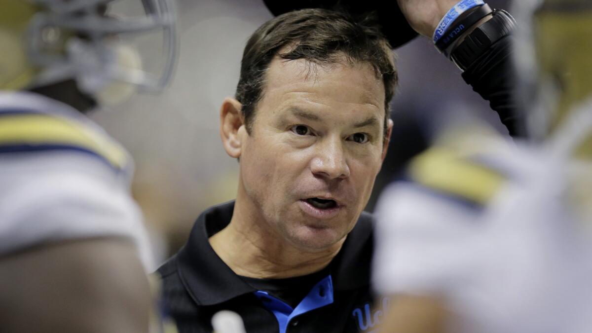 UCLA Coach Jim Mora speaks with his players during an Alamo Bowl win over Kansas State on Jan. 2.