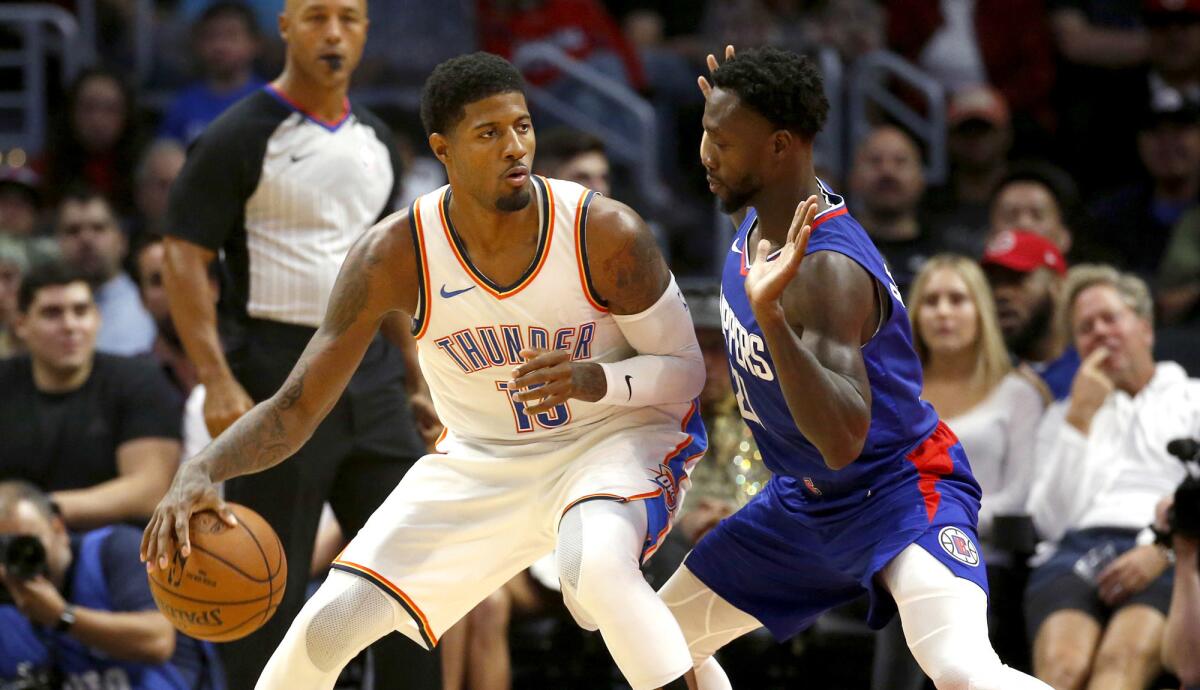 Clippers point guard Patrick Beverley defends against Thunder forard Paul George during their game Oct. 19 at Staples Center.