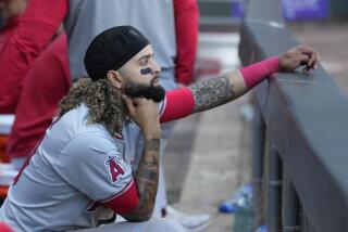 Los Angeles Angels' Jack López looks out from the dugout after his team's loss to the Chicago White Sox, setting a new franchise season record of 96 loses, in a baseball game Thursday, Sept. 26, 2024, in Chicago. (AP Photo/Charles Rex Arbogast)