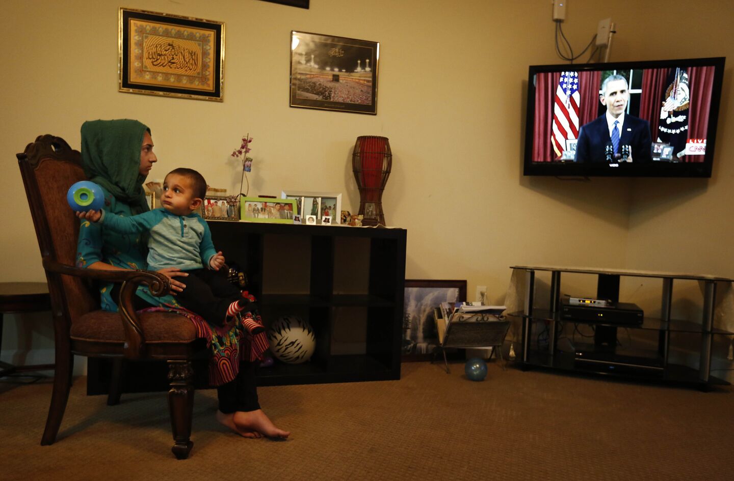 The Zafarullah family of Chino, originally of Pakistan, watches Obama's address. Arshia, at left, is holding her 18-month-old nephew, Sohail Ahmed.