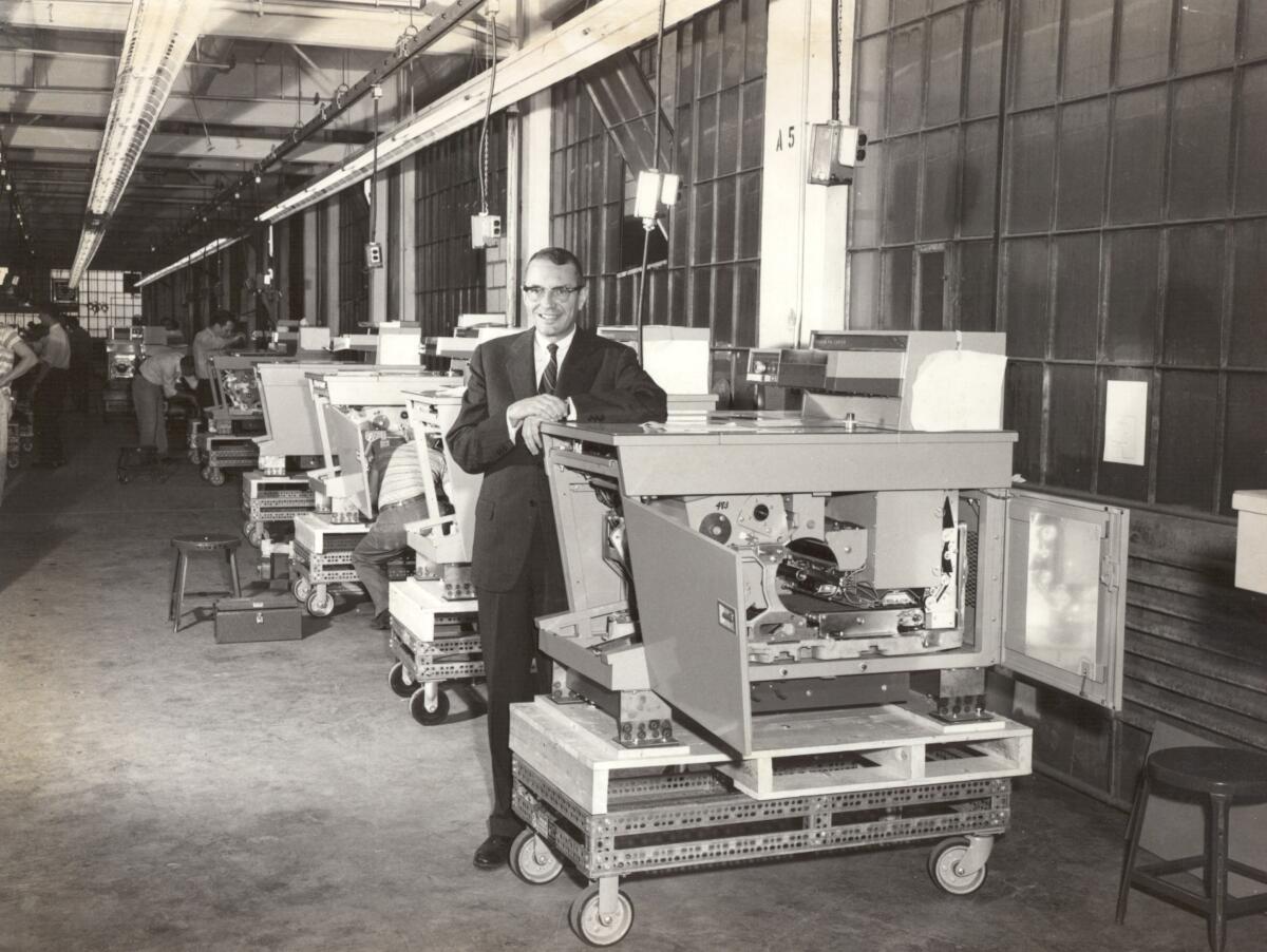 Xerox founder Joe Wilson on the assembly line of the company's signature 914 copier.