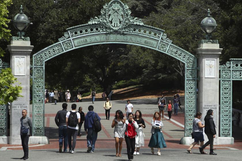 FILE - Students walk past Sather Gate on the University of California at Berkeley campus on May 10, 2018, in Berkeley, Calif. President Joe Biden's student loan forgiveness plan, announced in Aug. 2022, could lift crushing debt burdens from millions of borrowers. However, the tax man may demand a cut of the relief in some states, as some states tax forgiven debt as income. (AP Photo/Ben Margot, File)