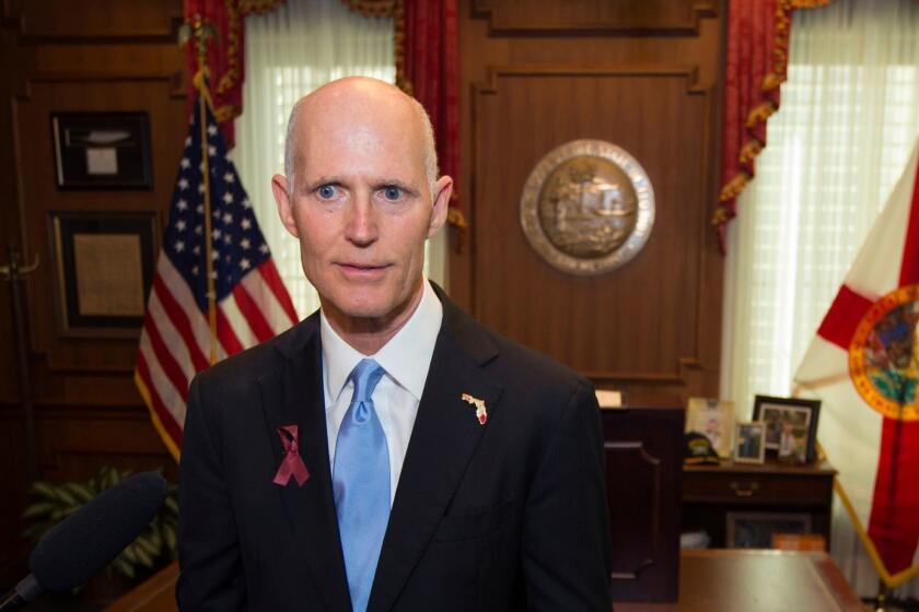 FILE- This March 9, 2018 file photo shows Florida Gov. Rick Scott talking to the media at the Florida Capital in Tallahassee, Fla. Attorney General Pam Bondi on Wednesday, April 4, 2018, appealed Judge Mark Walker's ruling to U.S. Court of Appeals for the Eleventh Circuit and asked that his order to overhaul the system by April 26 be put on hold. Gov. Scott and other Republican state officials are strongly defending the state's current system of restoring voting rights to ex-prisoners despite a federal judge's finding the system is flawed and potentially discriminatory. (AP Photo/Mark Wallheiser, File)