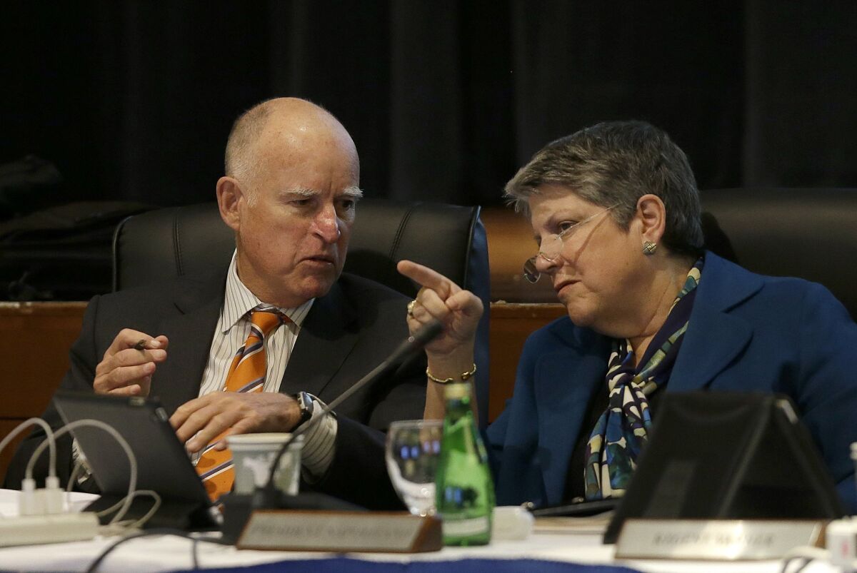 Gov. Jerry Brown talks with University of California president Janet Napolitano during a UC Board of Regents meeting in San Francisco on March 18.