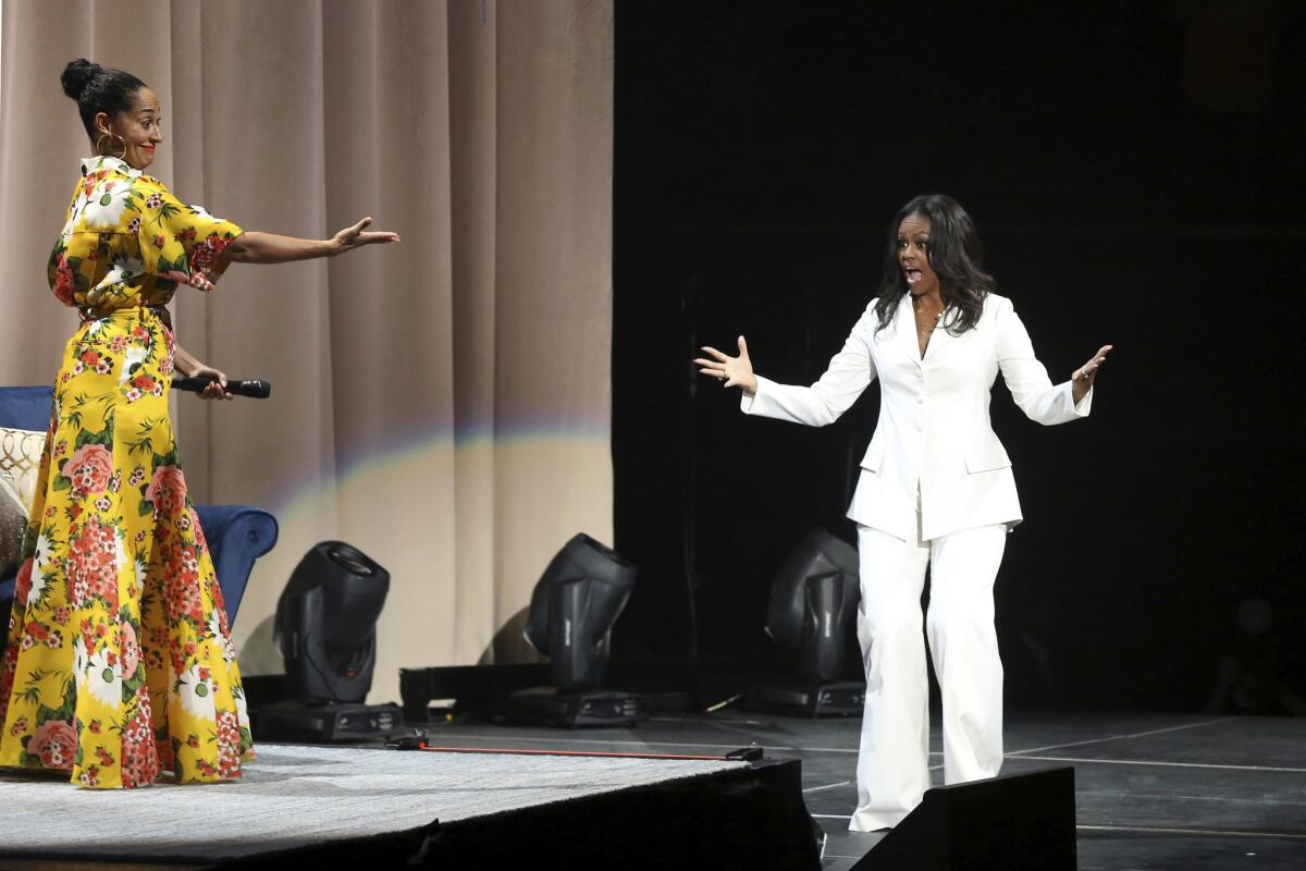 Tracee Ellis Ross, left, introduces former First Lady Michelle Obama at the "Becoming" event at the Forum in Inglewood on Thursday.