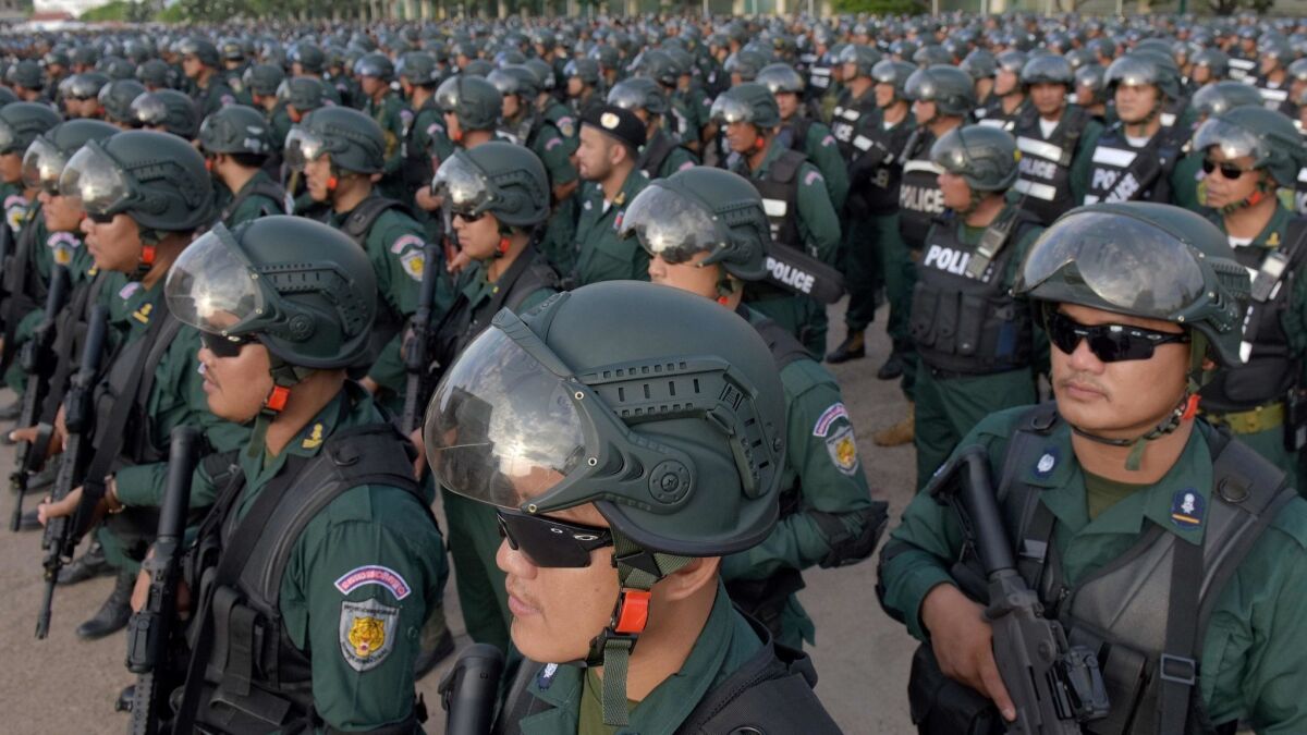 Cambodian police force stand in formation during an inspection ceremony at the National Olympic Stadium in Phnom Penh on July 25, 2018, in preparation for the general elections.