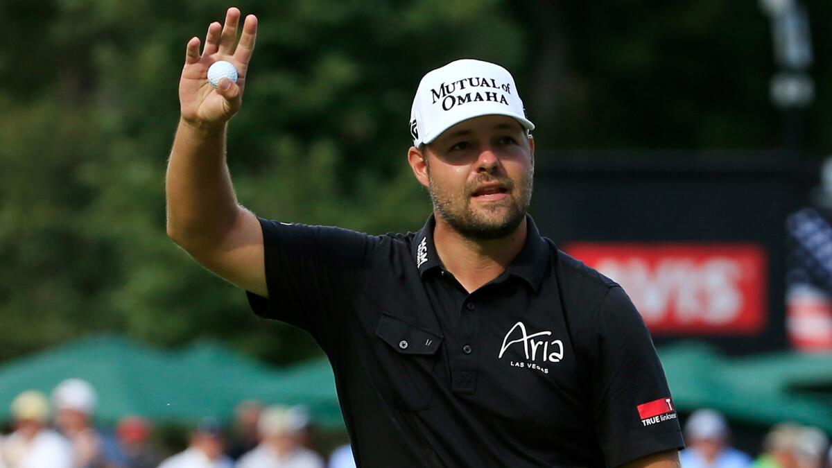 Ryan Moore acknowledges the crowd at No. 18 on Sunday after winning the John Deere Classic.