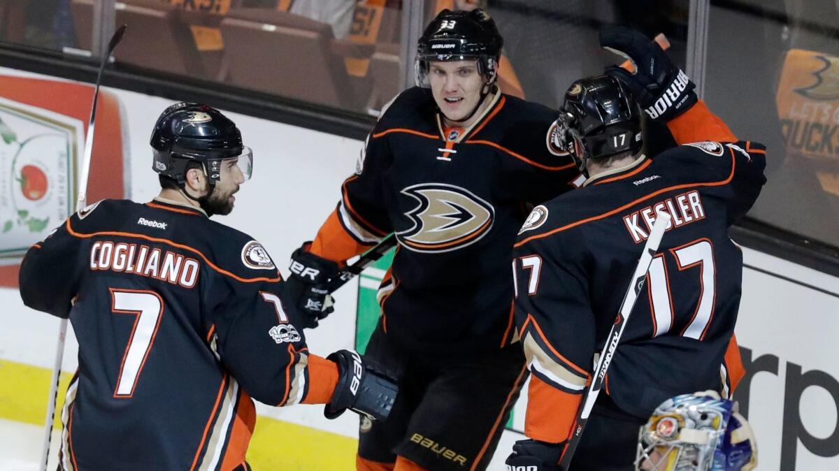 Jakob Silfverberg, center, is congratulated by teammates Andrew Cogliano and Ryan Kesler after scoring a goal in Game 1 against Nashville.