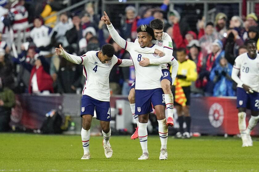 FILE - United States' Weston McKennie celebrates his goal with Tyler Adams, left, and Christian Pulisic during the second half of a FIFA World Cup qualifying soccer match against Mexico, Friday, Nov. 12, 2021, in Cincinnati. The U.S. won 2-0. Having revived their careers in Italy, AC Milan's Christian Pulisic and Juventus' Weston McKennie are looking forward to facing each other later this month in Serie A before joining the U.S. national team for the Copa América. (AP Photo/Julio Cortez, File)