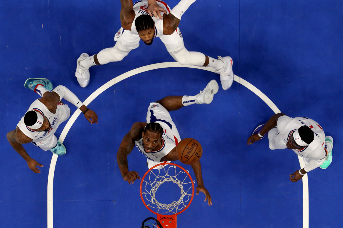 Clippers forward Kawhi Leonard, bottom, grabs a rebound in front of his teammates.