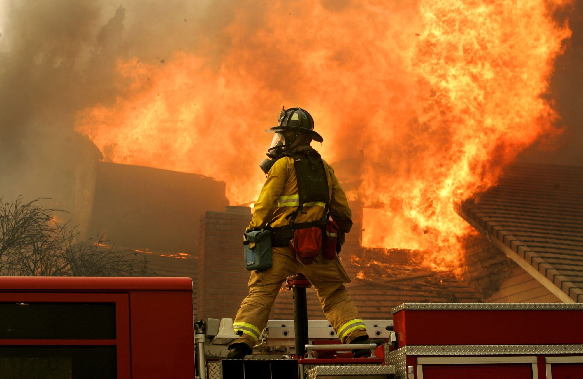 A San Diego firefighter battles a blaze in Rancho Bernardo during a firestorm on Monday, October 22, 2007.