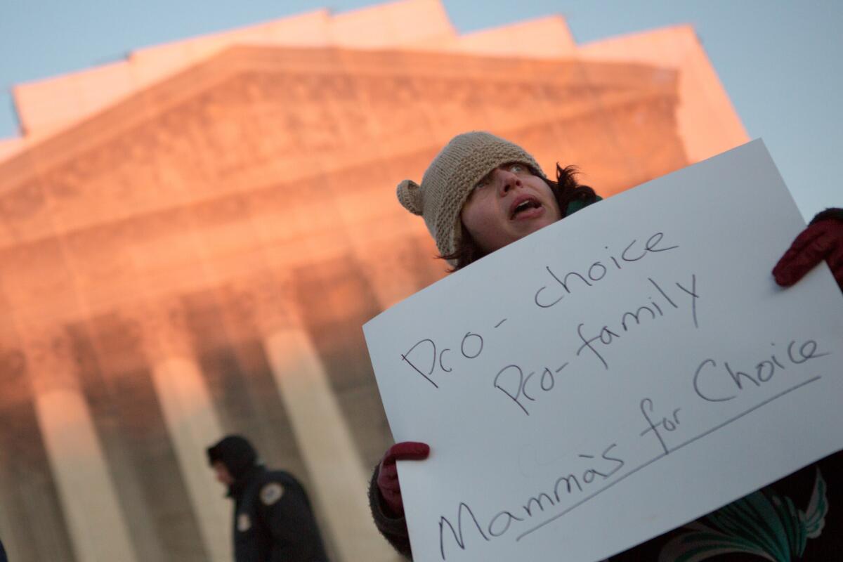 Attendees march during a candlelight vigil organized by the National Organization for Women in front of the U.S. Supreme Court to commemorates Roe v. Wade in 2013.