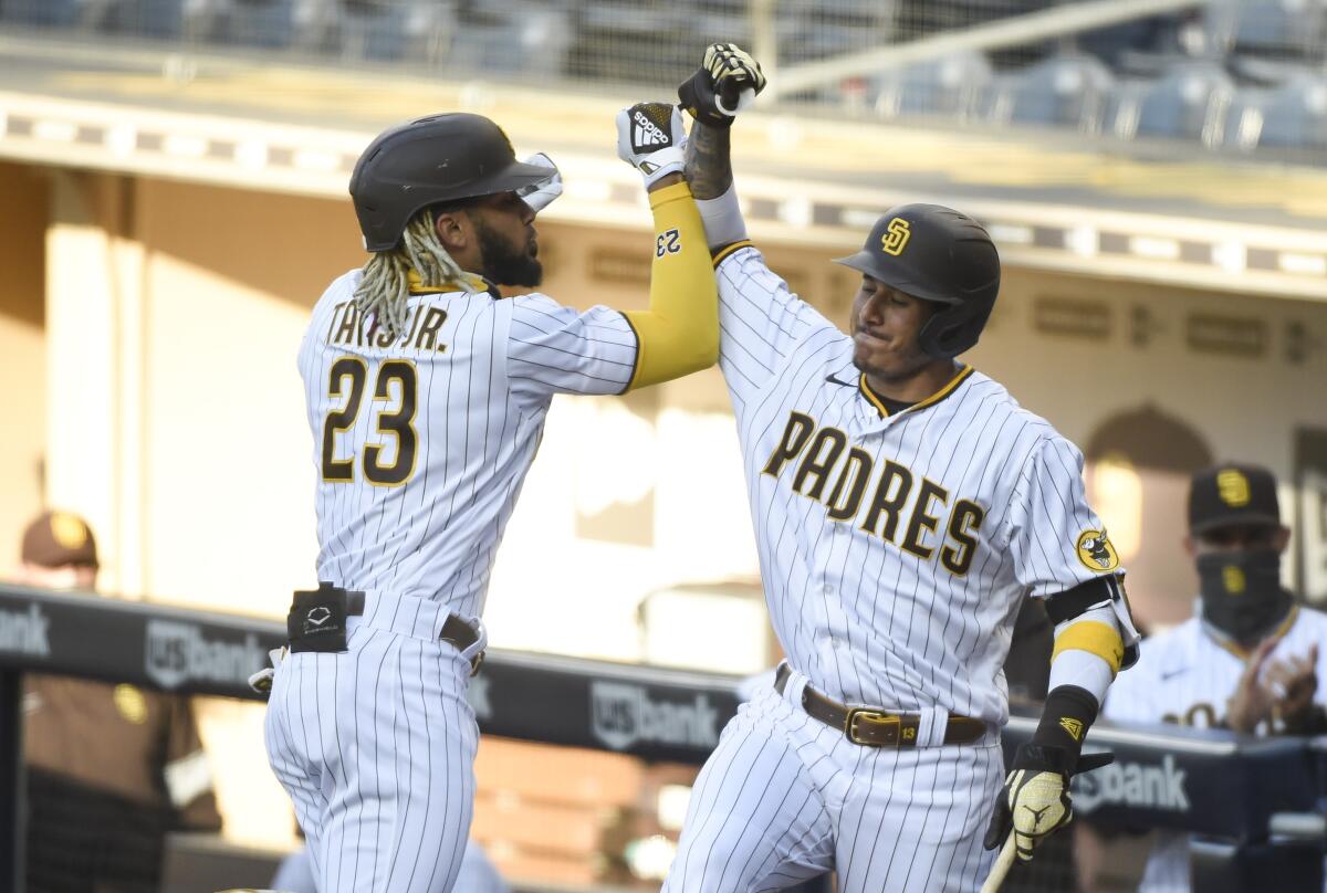 Fernando Tatis Jr. of the San Diego Padres is congratulated by Manny Machado after hitting a solo home run.