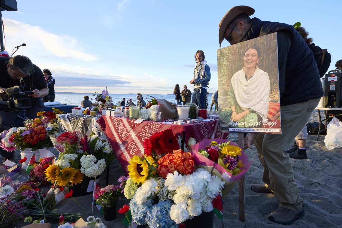 A photo is placed among flowers in memory of 26-year-old Aysenur Ezgi Eygi at a vigil.