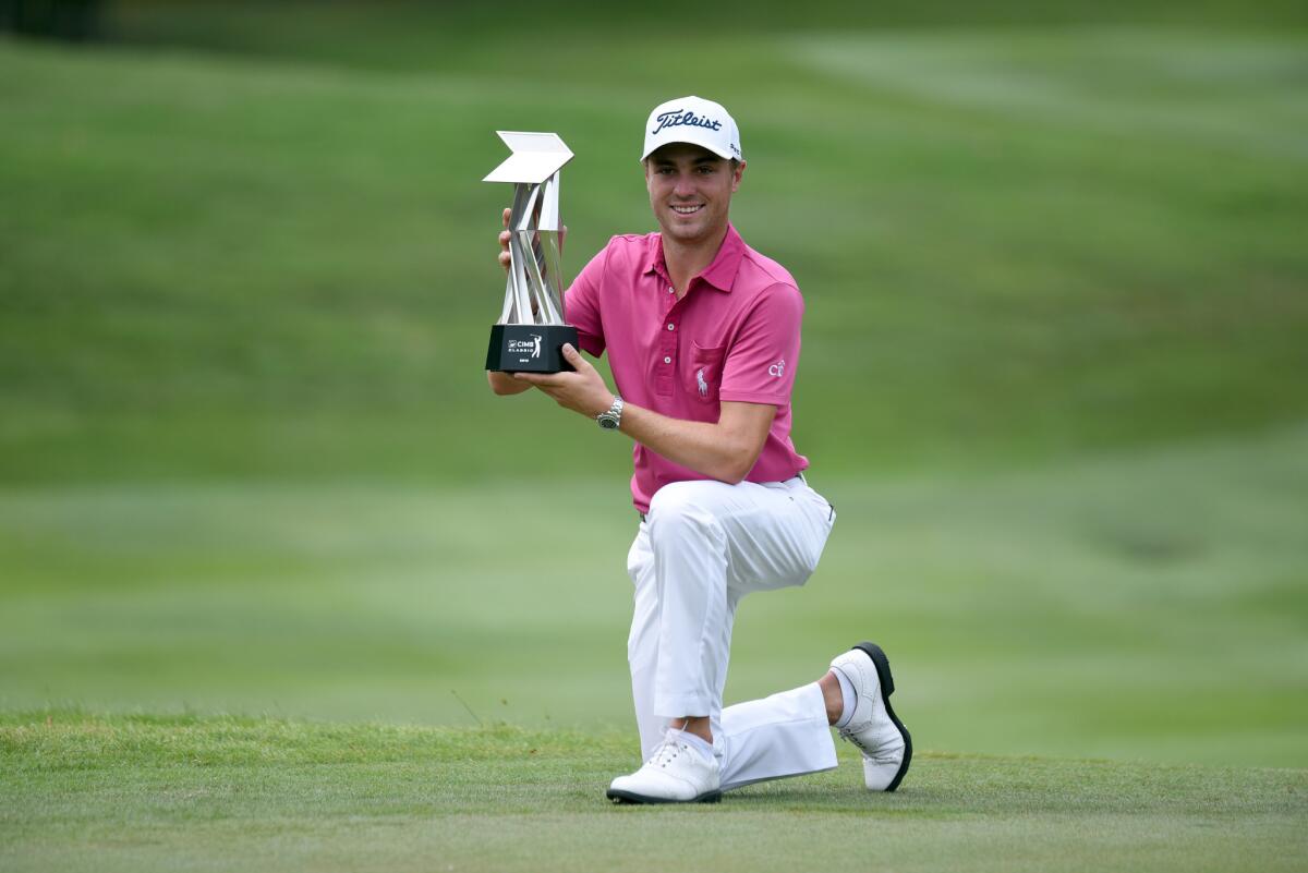 Justin Thomas poses with the CIMB Classic Trophy on Oct. 23 after he won with a score of under-23 at TPC Kuala Lumpur.