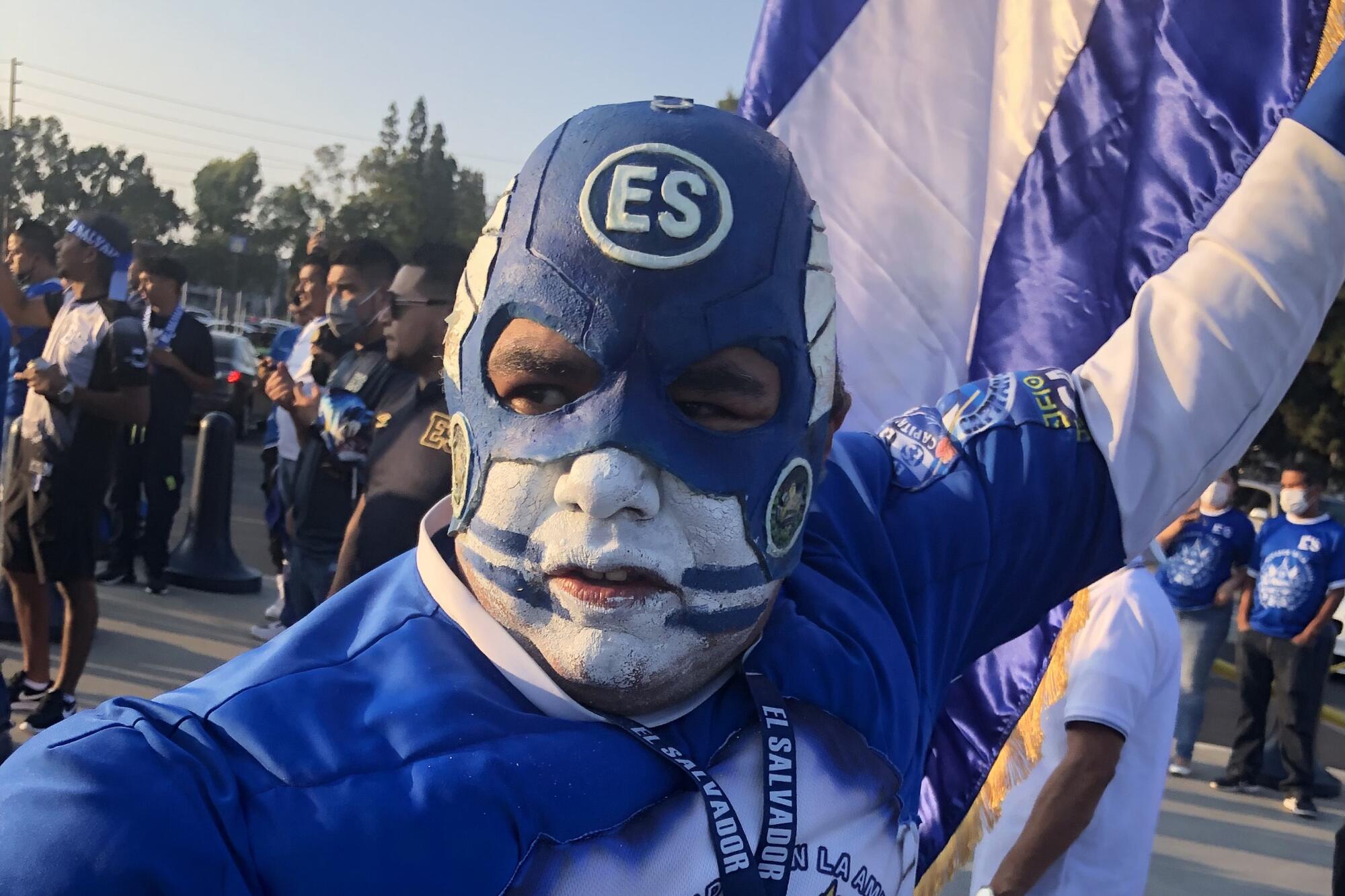 Mario Valladares, of Los Angeles, dresses up as Capitan Cuscatleco and waves the Salvadoran flag 