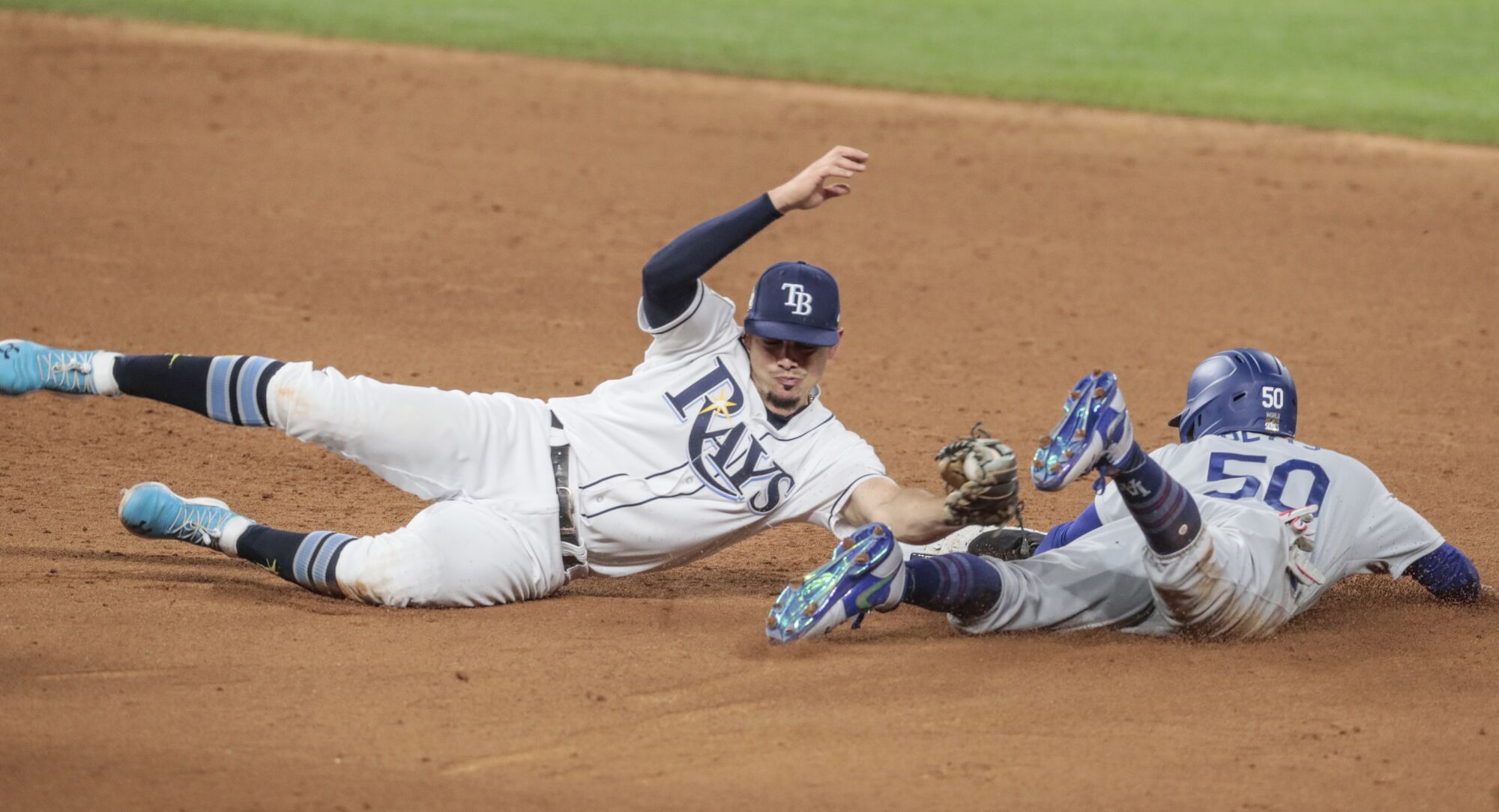 Dodgers baserunner Mookie Betts beats the tag by Tampa Bay Rays shortstop Willy Adames to steal second.