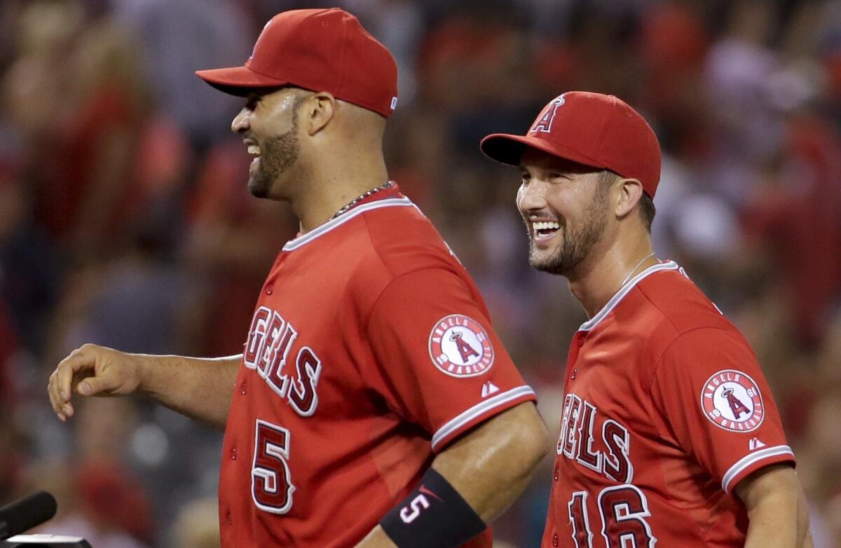 Albert Pujols and Huston Street, right, celebrate after a 2-1 victory Friday over the Detroit Tigers at Angel Stadium