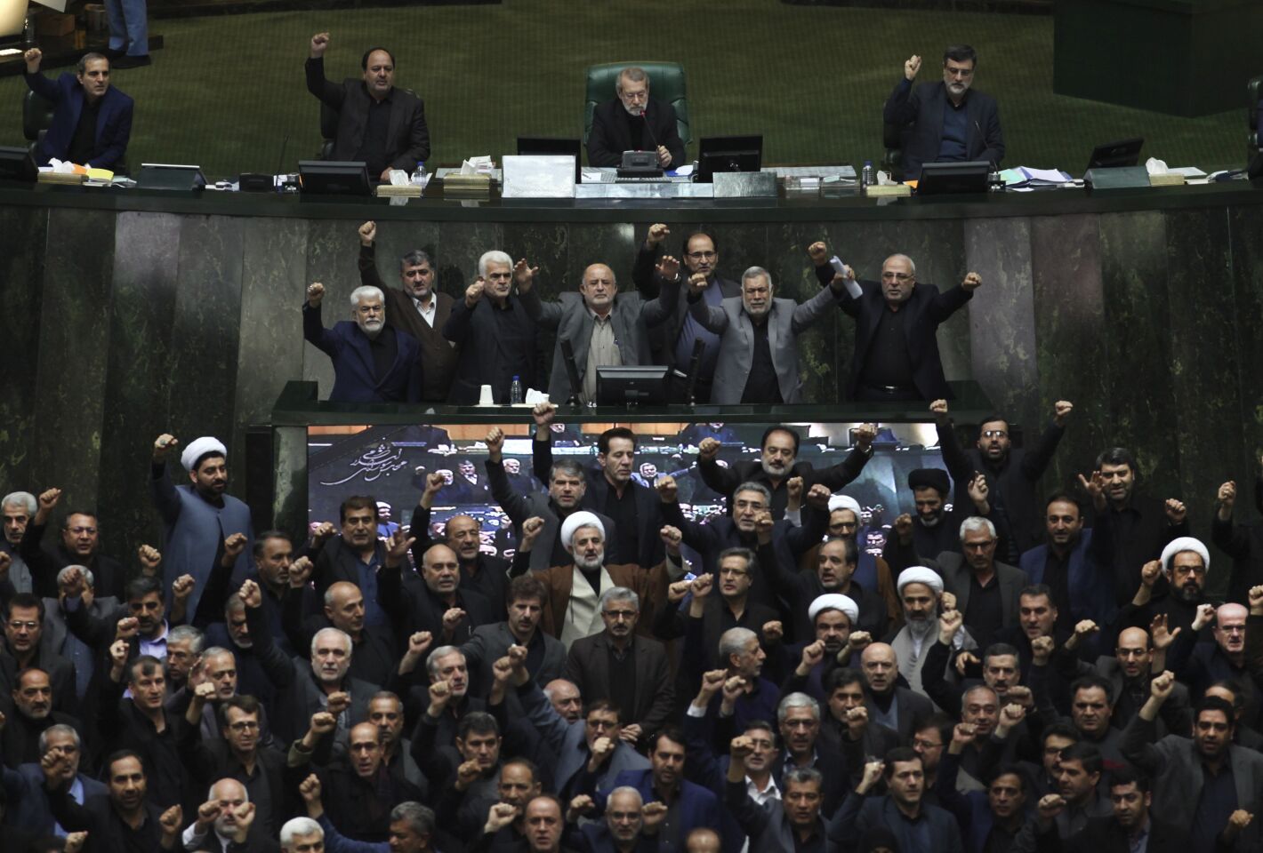 Iranian lawmakers chant anti-American and anti-Israeli slogans to protest against the U.S. killing of Iranian top general Qassem Suleimani, at the start of an open session of parliament in Tehran, Iran.