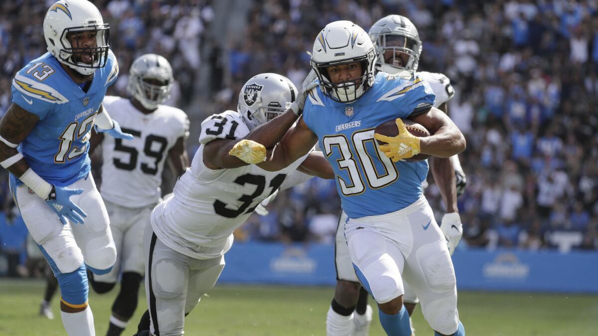 Chargers running back Austin Ekeler outruns the Raiders defense for a 44-yard touchdown on a screen pass from Philip Rivers at StubHub Center.