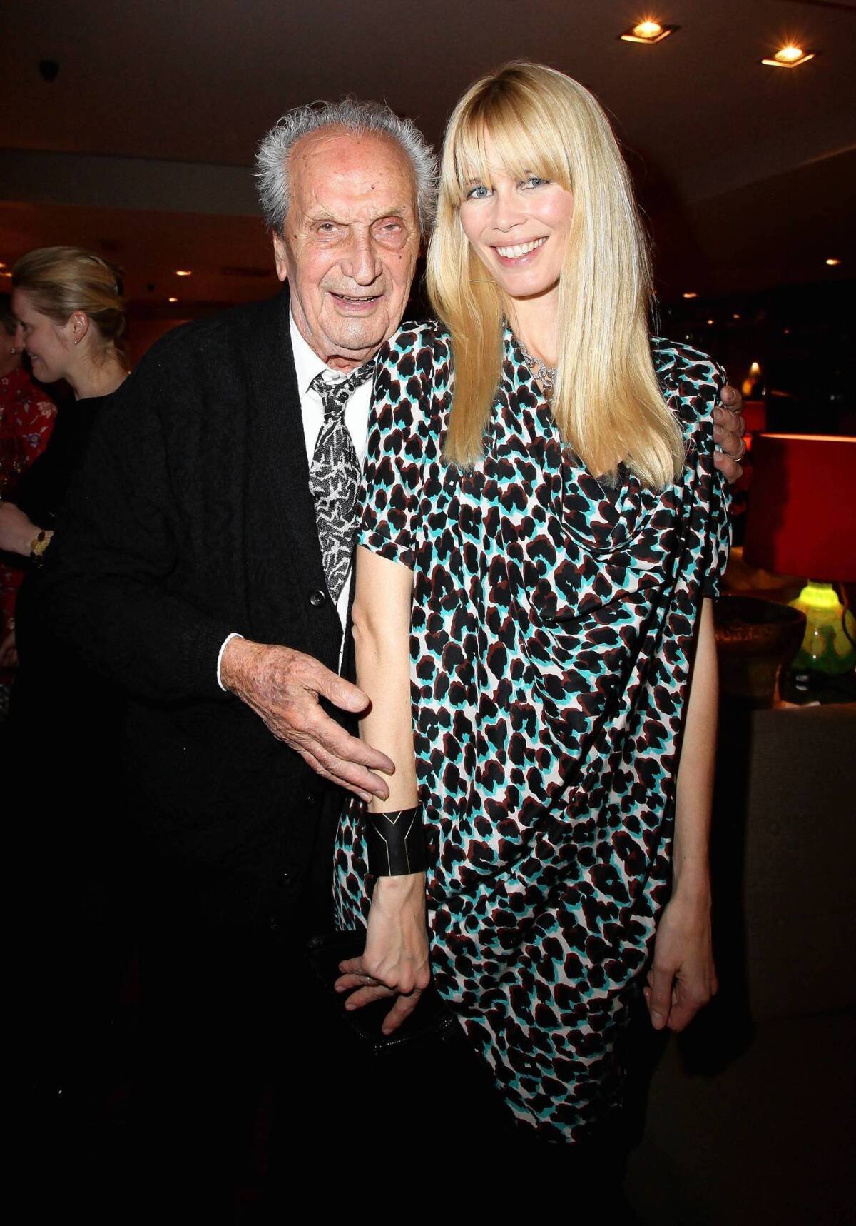Ottavio Missoni visits with Claudia Schiffer at a Berlin event in 2009. The Italian fashion patriarch died Thursday at 92.