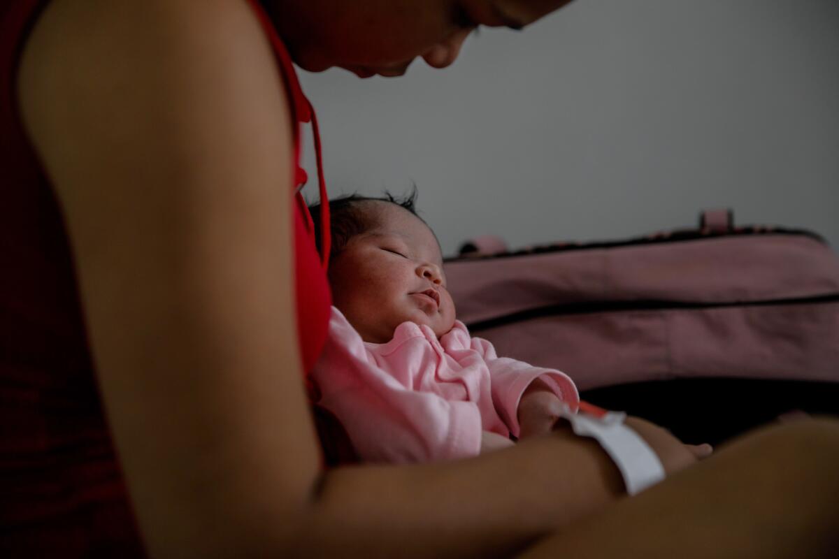 Venezuelan Juberkis Alvarez Guanipa, 19, and newborn daughter Dariagnny rest at the Hospital Materno Infantil in Bogota, Colombia.
