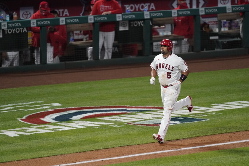 The Angels' Albert Pujols runs toward home plate after hitting a three-run home run in the fourth inning.