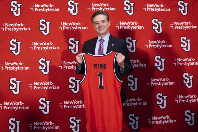 New St. John's NCAA college basketball head coach Rick Pitino holds up a jersey after being introduced during a news conference at Madison Square Garden in New York, Tuesday, March 21, 2023. (AP Photo/Corey Sipkin)