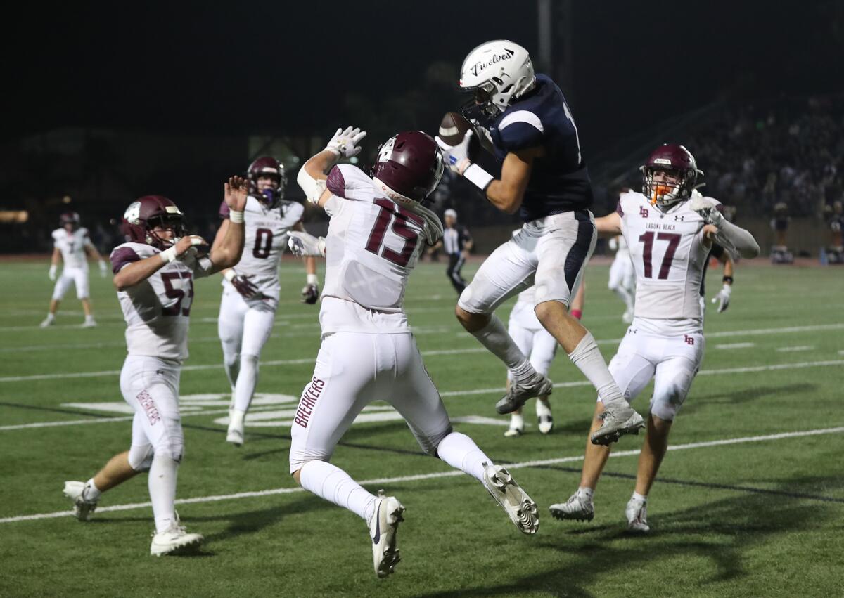 Northwood's Cole Hidalgo (1) is surrounded by Laguna Beach defenders on a key fourth-down play in the fourth quarter.