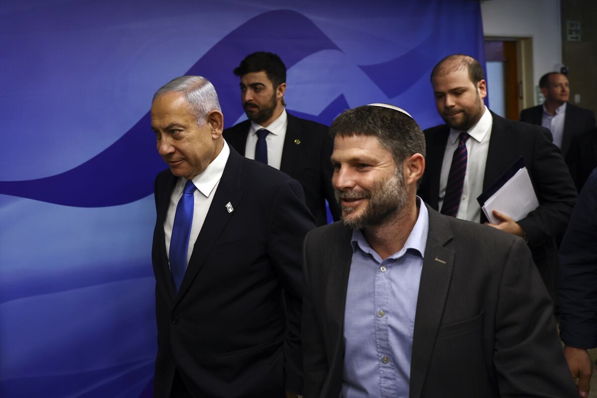 FILE - Israeli Prime Minister Benjamin Netanyahu, left, and Finance Minister Bezalel Smotrich, right, arrive to attend a cabinet meeting at the Prime Minister's office in Jerusalem, Feb. 23, 2023. The ultranationalist member of Israel's ruling coalition says there's no such thing as a Palestinian people. Finance Minister Smotrich's remark Sunday, March 19, came within hours of efforts to calm tensions between Israel and the Palestinians over the country's contentious plan to overhaul the judiciary. (Ronen Zvulun/Pool Photo via AP, File)