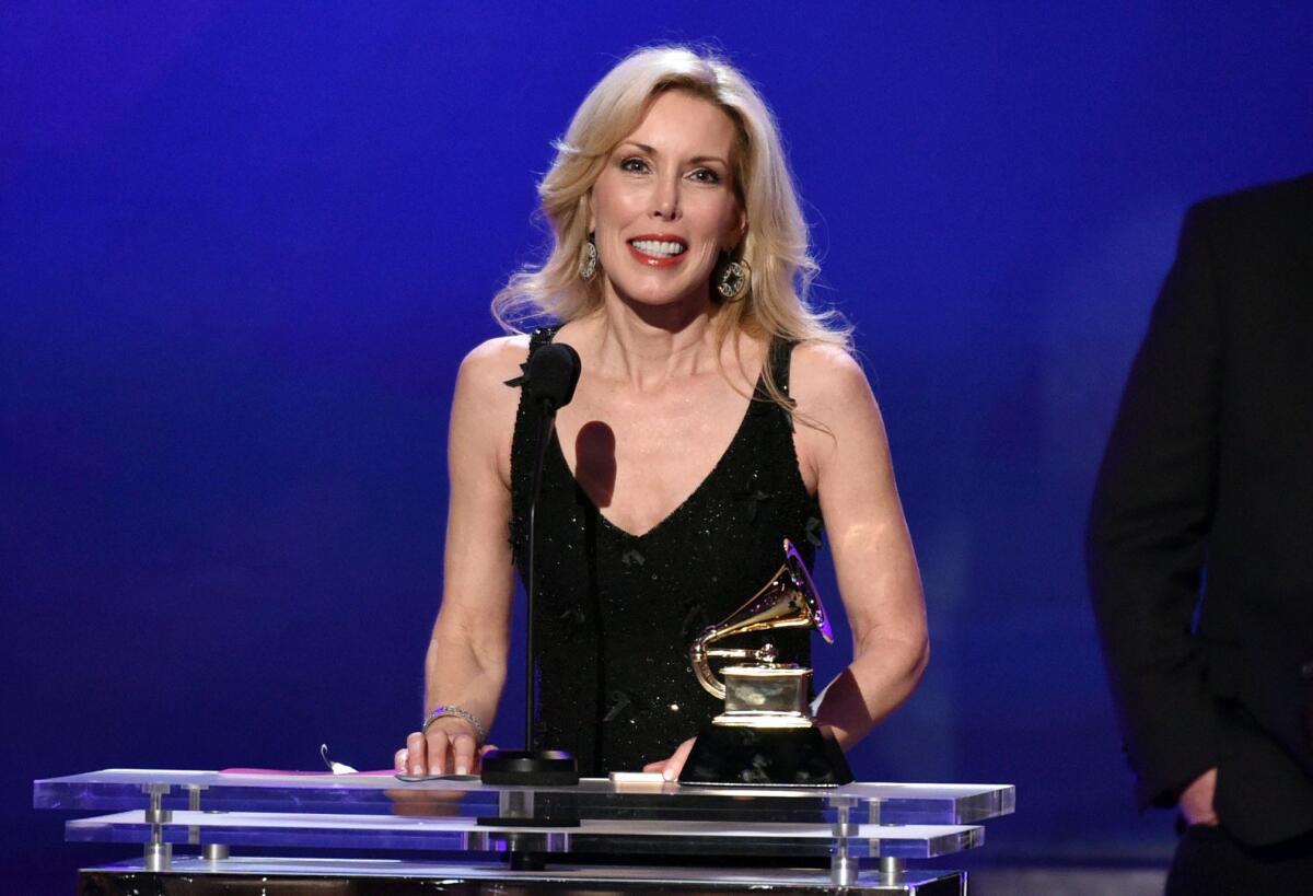 Kimberly Campbell accepts the award for best country song for "I'm Not Gonna Miss You" on behalf of her husband, Glen Campbell, at the Grammy Awards on Sunday.