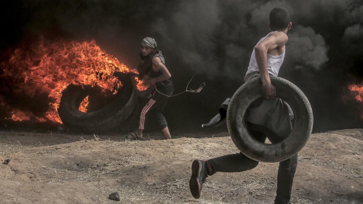 Palestinians protesters burn tires during clashes near the border with Israel in the east of Gaza City on Friday.