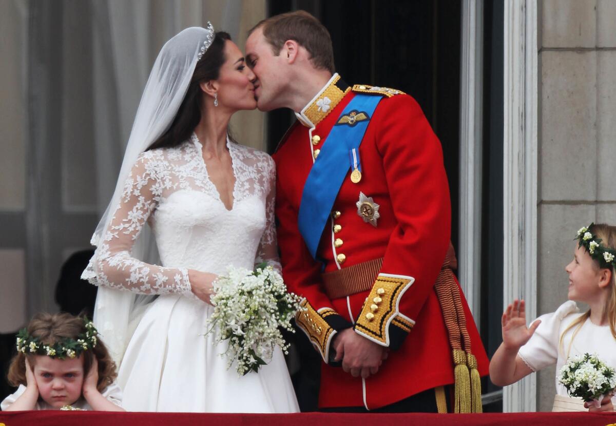 April 29, 2011: Prince William and Kate Middleton kiss on the balcony of Buckingham Palace following their wedding.