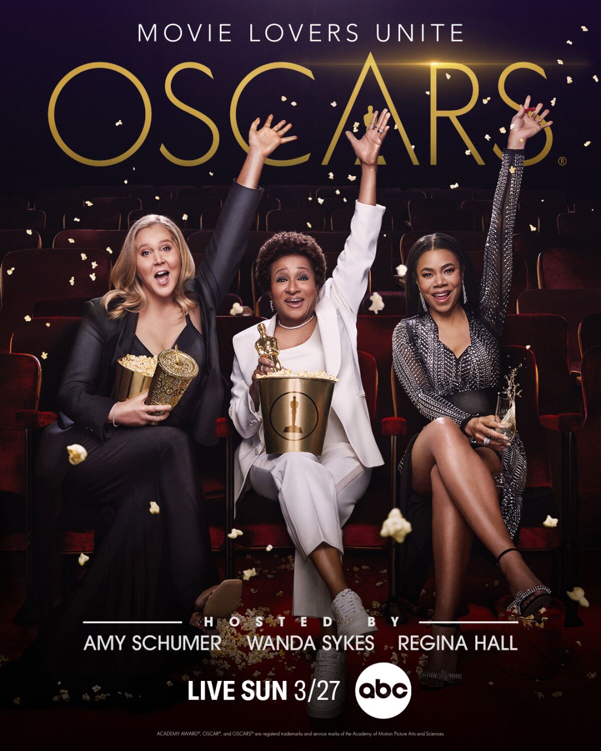 A poster showing three women holding buckets of popcorn and raising their hands
