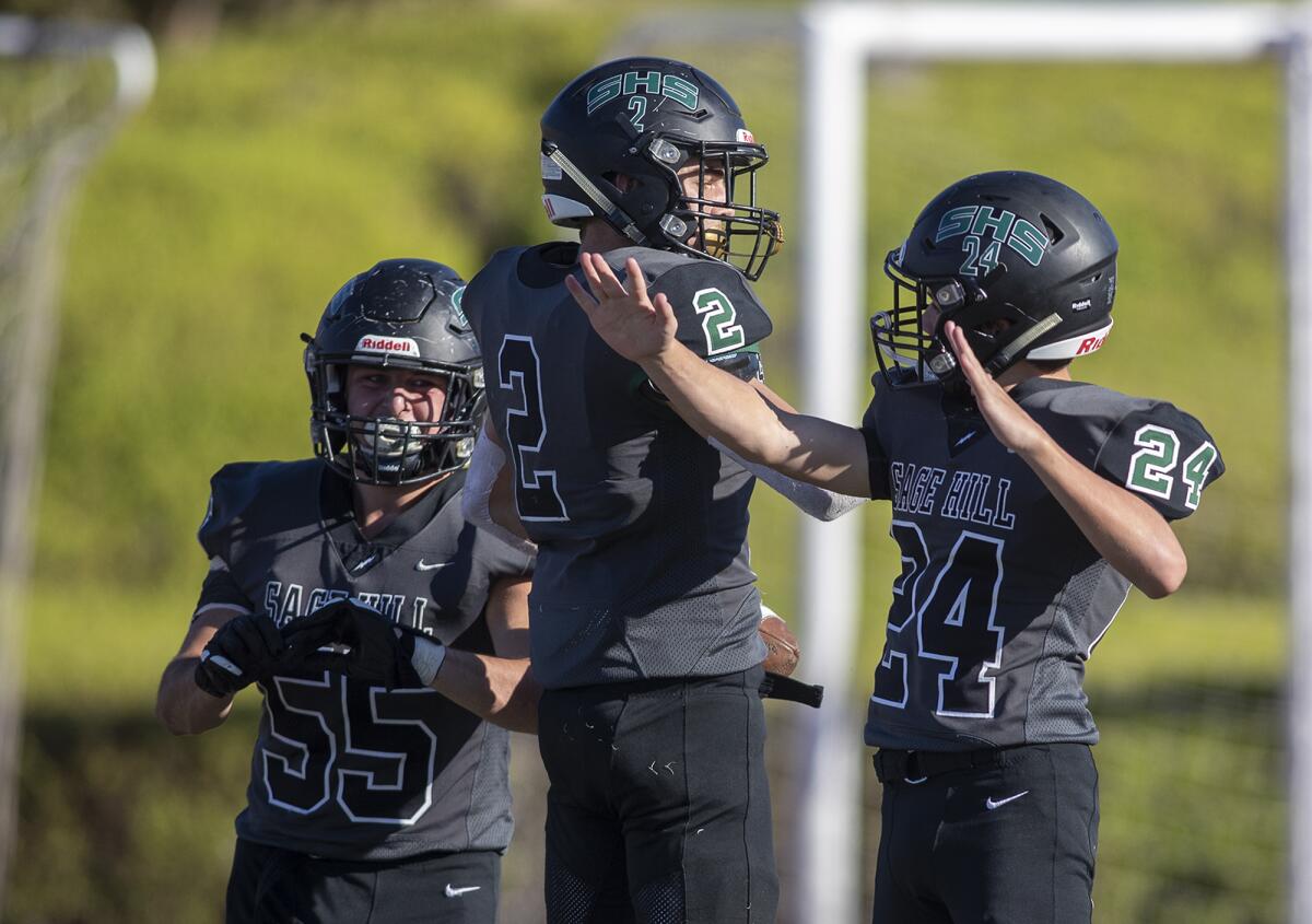 Sage Hill's Ben Romeo, center, celebrates with teammates after scoring a touchdown against Avalon in the Express League title game on Friday.