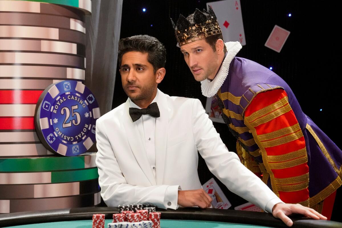 A dealer at a poker table with a man in a king's costume behind him