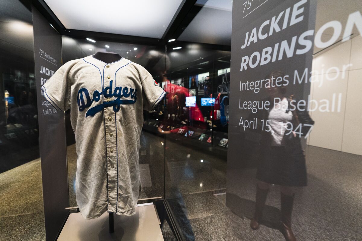 A jersey of Jackie Robinson is displayed at the National Museum of African American History and Culture in Washington, commemorating the 75th anniversary of Jackie Robinson's integration of Major League Baseball, Thursday, April 7, 2022. Robinson became the first African American to play in Major League Baseball breaking the baseball color barrier on April 15, 1947, when he started at first base for the Brooklyn Dodgers. (AP Photo/Manuel Balce Ceneta)