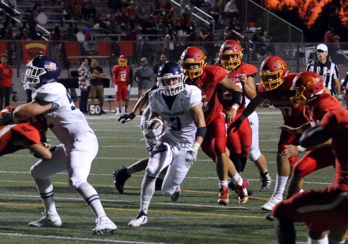 Newport Harbor running back Justin McCoy runs through the middle against Woodbridge in a nonleague game at University High on Aug. 23.