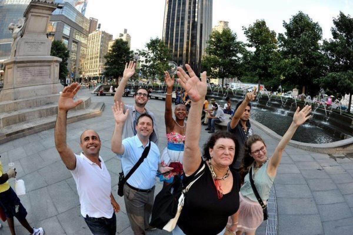 New Yorkers wave at Saturn from Columbus Circle on Friday.