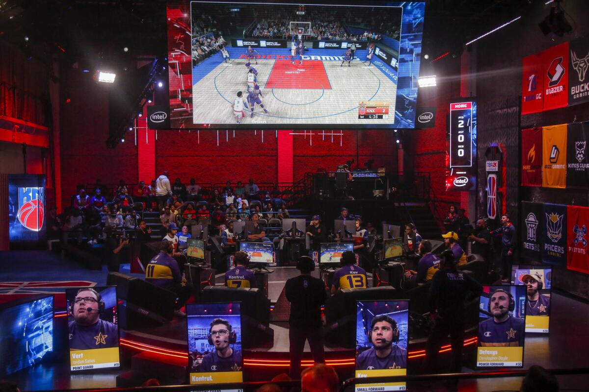 Members of the Lakers Gaming team play against Kicks Gaming in the NBA 2K League Studio in Long Island, N.Y., on June 5. 