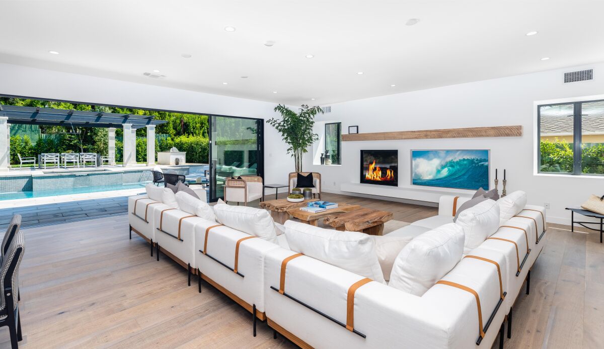 The four-bedroom home boasts an indoor-outdoor floor plan with white walls and white oak floors.
