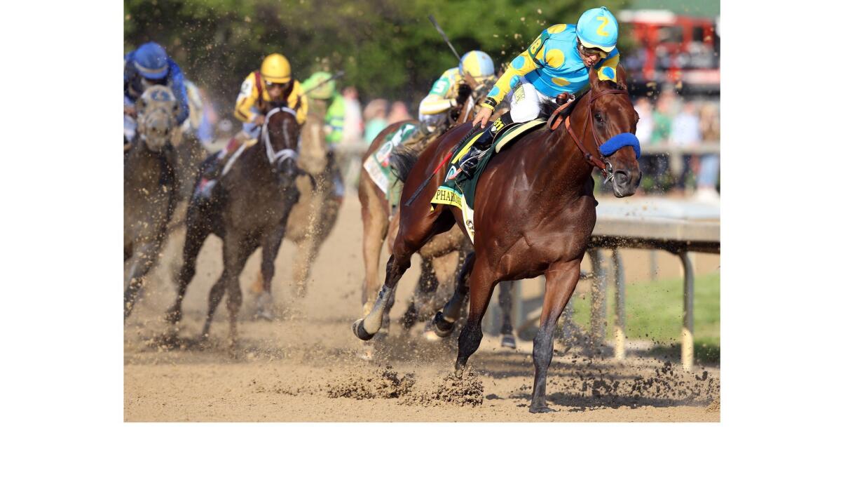 Kentucky Derby winner American Pharoah, ridden by Victor Espinoza, comes out of turn 4 at Churchill Downs on Saturday.