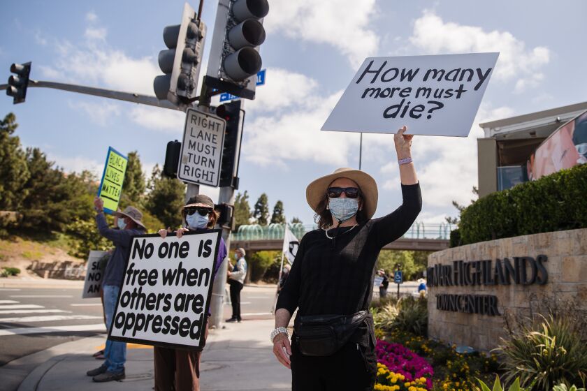 The Carmel Valley for Equal Justice group hold a racial justice rally at the corner of Del Mar Heights and El Camino Real Road in Carmel Valley on May 22, 2021.