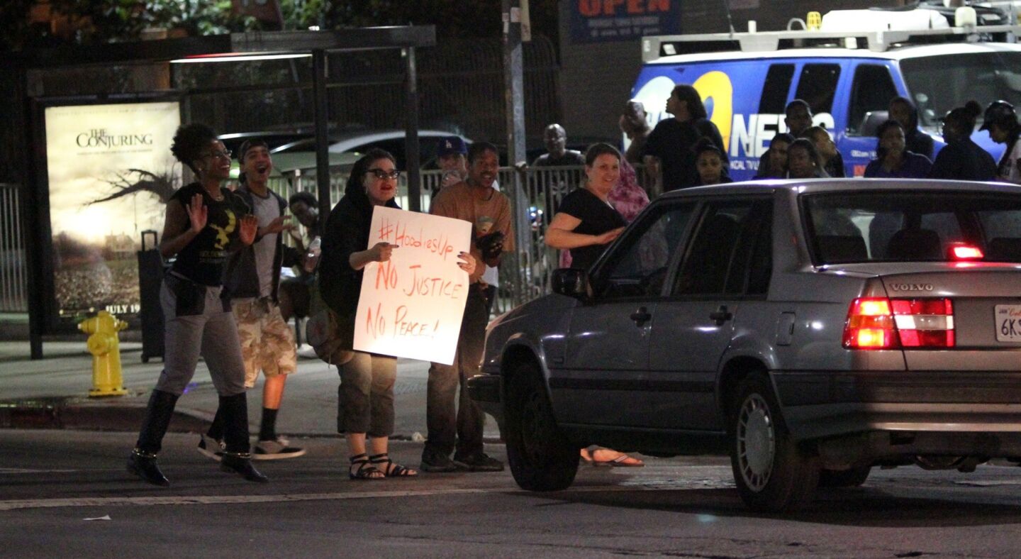 A handful of protesters block the intersection at Crenshaw and Adams boulevards on Sunday night to protest a Florida jury's decision that George Zimmerman is not guilty of murdering Trayvon Martin.