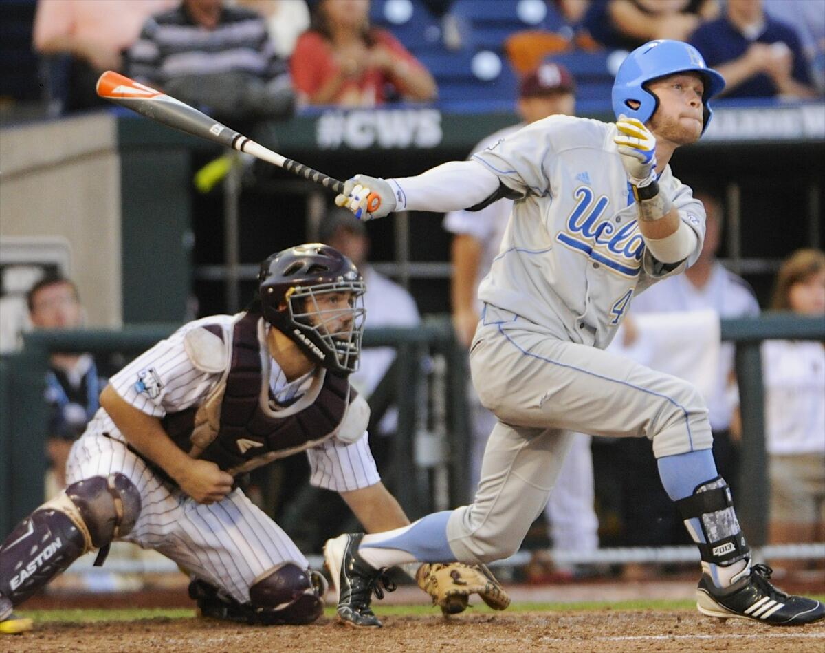 UCLA's Eric Filia follows through on a two-run single during the fourth inning of the Bruins' 3-1 victory in Game 1 of the College World Series on Monday.