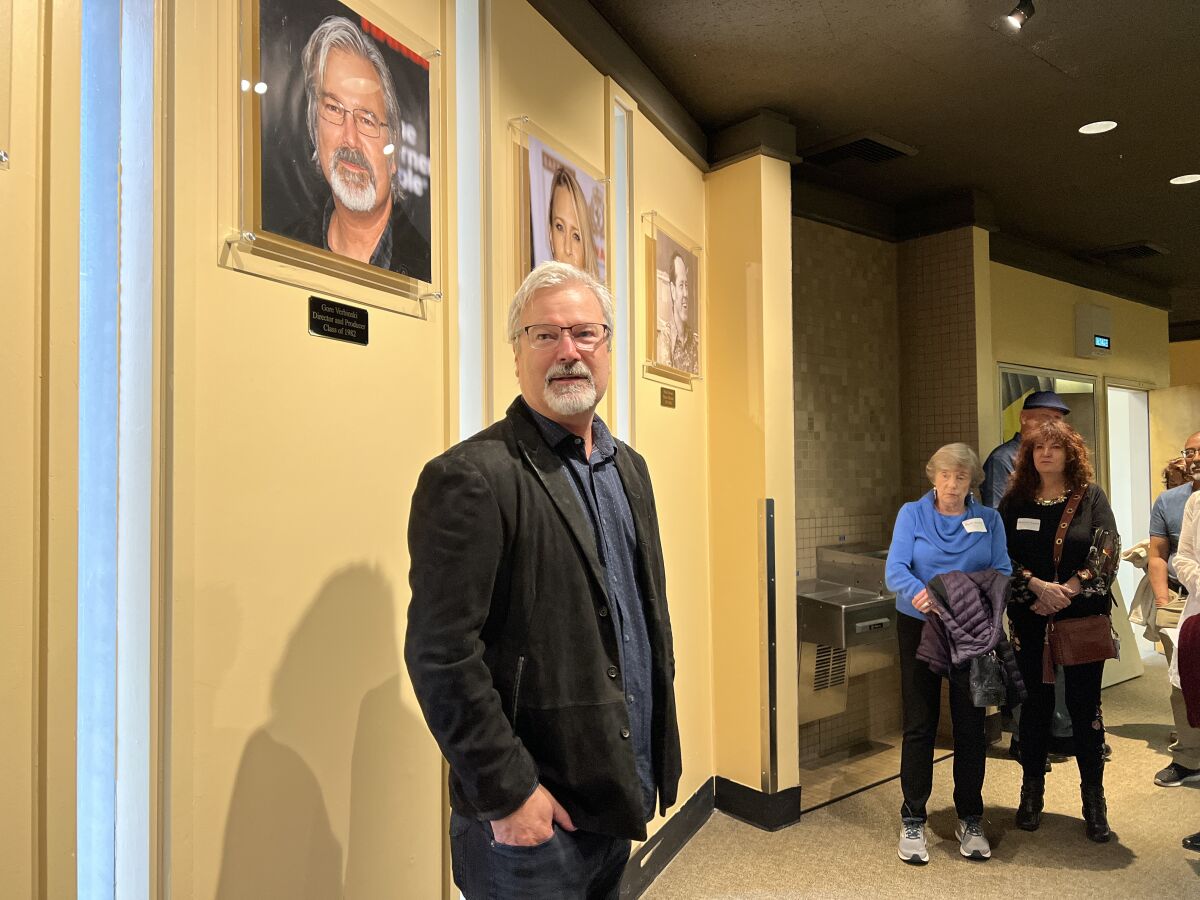 Film director and producer Gore Verbinski stands under his photo on La Jolla High School's Wall of Fame at Parker Auditorium.