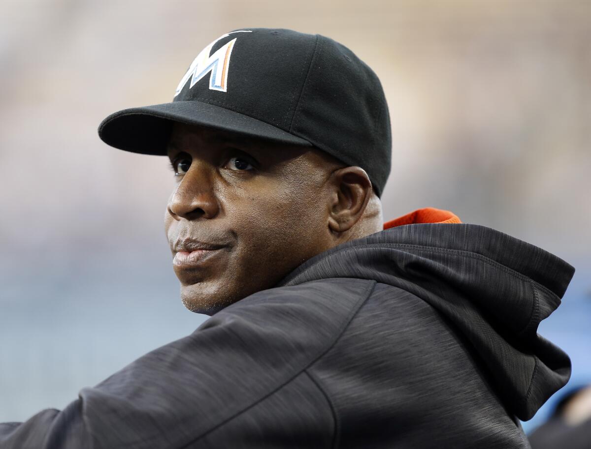 Barry Bonds looks on from the dugout during a game while coaching with the Miami Marlins in 2016.