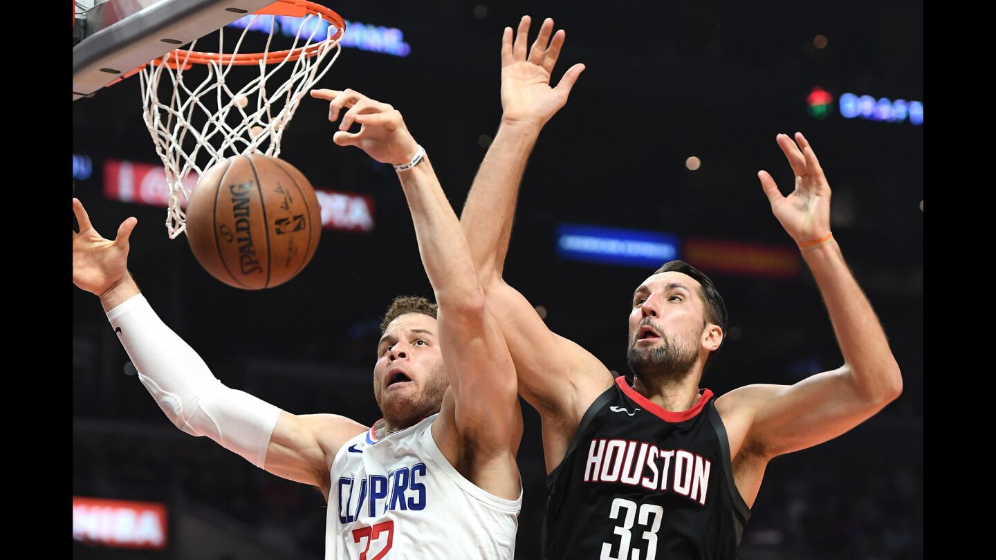 Clippers' Blake Griffin and Houston Rockets' Ryan Anderson battle for a rebound.