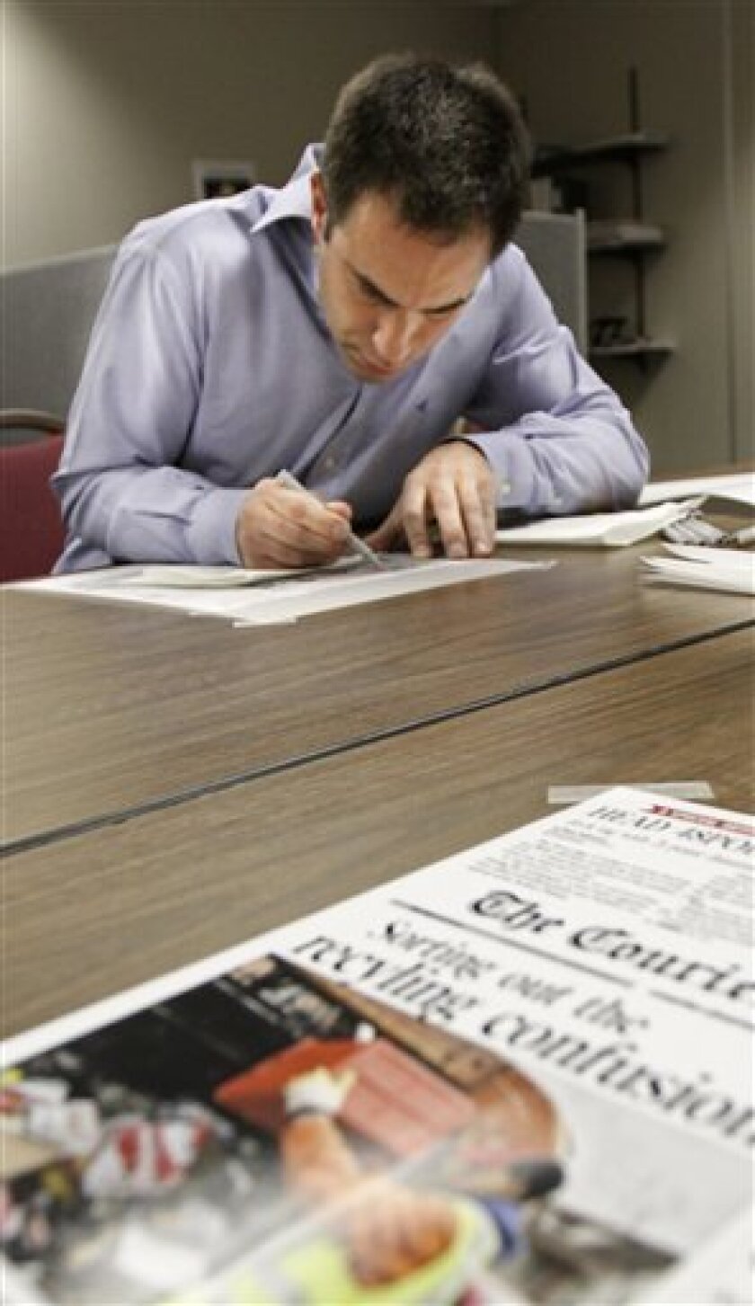 Turkish artist Serkan Ozkaya draws the front page of Louisville The Courier-Journal for the April, 10th issue Thursday, April 9, 2009. (AP Photo/Louisville Courier-Journal, Scott Utterback) Apr. 9, 2009