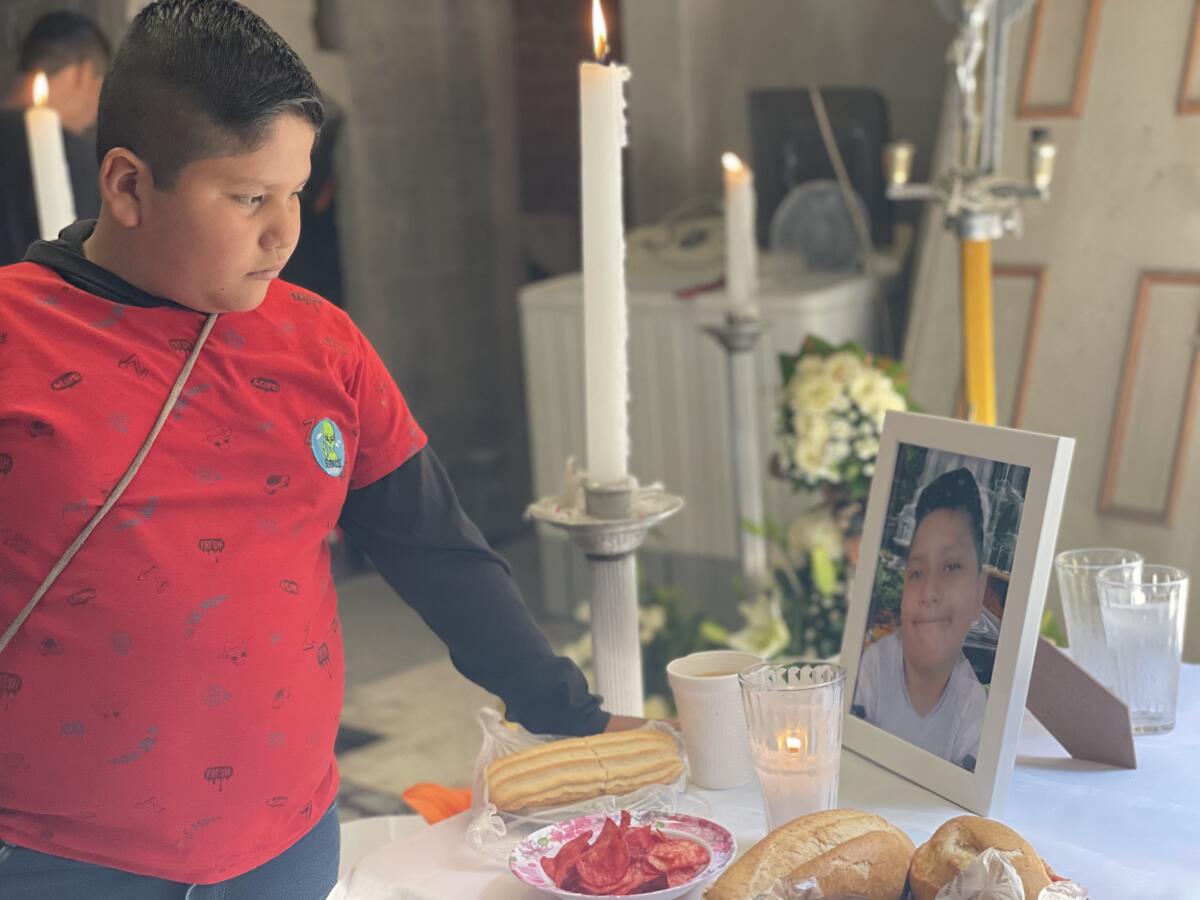 Bryan Osvaldo Hernández, de 10 años, mira en el altar a su hermano Brandon Giovanni Hernández Tapia